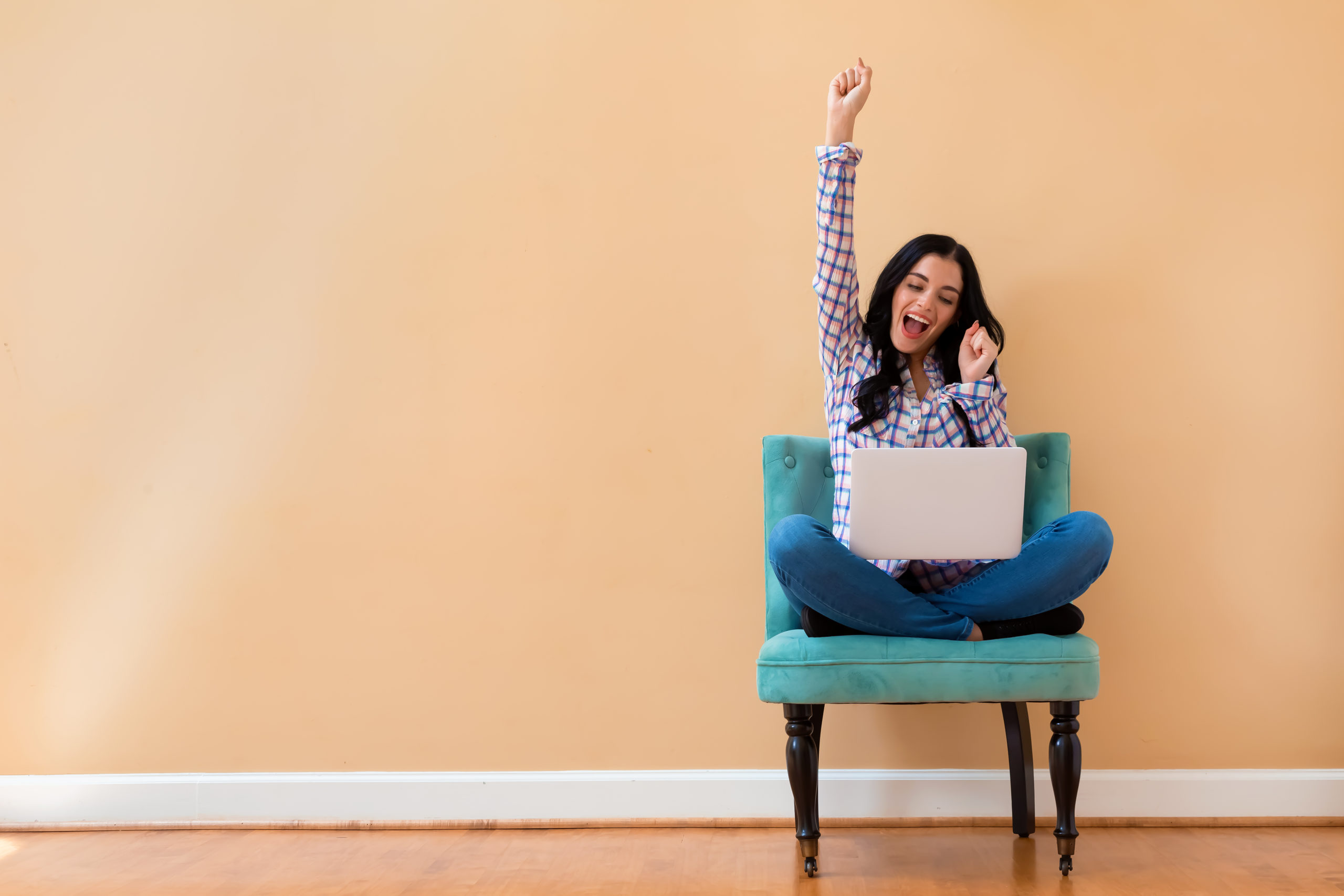 Young,Woman,With,A,Laptop,Computer,With,Successful,Pose,Sitting