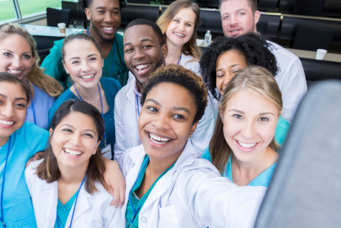Confident medical student takes selfie with friends